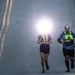 Truro- May 4, 2018- Stan Grossfeld/Globe Staff- Support runner Lindsay Ruthven (left) lights the way for fromTeam Spencer's Mike McGrail on the downhill from Truro. Ruck4HIT organizers allowed two night support runners-Friday night 7pm-7 am Saturday morning for support runners to accompany runners during the hardest few hours of the event..