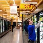 A worker stocked shelves in the frozen foods section at the new Wegmans in the Natick Mall. 