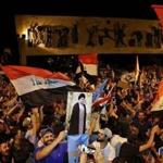 Followers of Shi?ite cleric Moqtada al-Sadr, seen on a poster, celebrated in Tahrir Square in Baghdad on Monday after election results showed Sadr?s coalition getting the most votes. 