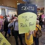 People fill a hallway before a Seattle City Council meeting where the council was expected to vote on a 