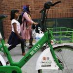 Cambridge, MA--5/14/2018-- People walk past an Ant Bicycle parked outside of the Garment District on Broadway is seen in Kendall Square. dockless bike share (Jessica Rinaldi/Globe Staff) Topic: 12bikeshare Reporter: