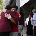 Amherst, MA--5/17/2018-- Lucio Perez (C) embraced Milta Franco, of Springfield after he came out to thank supporters who created a caravan to help him return to the church where he has been sheltered in sanctuary for the past seven months after a trip to the hospital for an emergency appendectomy. Clergy members and supporters created a caravan to shepherd him from the hospital in Northampton back to the church in Amherst so that ICE wouldn't try to detain him as he left. (Jessica Rinaldi/Globe Staff) Topic: 17sanctuarypic Reporter:
