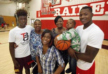 Tre?Dasia Tucker (front), who has cerebral palsy, has plenty of support from her brother, Celtics guard Terry Rozier (far right), and the rest of her  family. They are, from left, brother, B.J. Carter, grandmother Amanda Tucker, mother Gina Tucker and Terry?s son, Justin Rozier.
