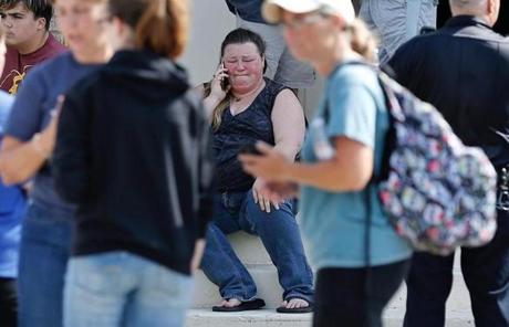 TEXAS SHOOTING SLIDER A woman reacts while making a phone call outside the Alamo Gym where parents wait to reunite with their children following a shooting at Santa Fe High School in Santa Fe, Texas, on Friday, May 18, 2018. (Michael Ciaglo/Houston Chronicle via AP)

