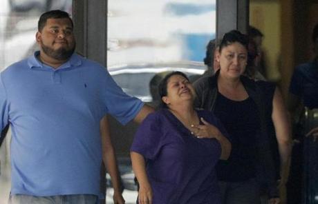 TEXAS SHOOTING SLIDER People react as they leave the family unification center at the Alamo Gym, following a shooting at Santa Fe High School Friday, May 18, 2018, in Santa Fe, Texas. (AP Photo/David J. Phillip)

