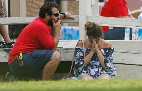 TEXAS SHOOTING SLIDER A woman prays in the grass outside the Alamo Gym where parents wait to reunite with their kids following a shooting at Santa Fe High School Friday, May 18, 2018, in Santa Fe, Texas. (Michael Ciaglo/Houston Chronicle via AP)
