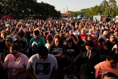 Mandatory Credit: Photo by MATT PATTERSON/EPA-EFE/REX/Shutterstock (9683337ag) People listen to speakers at a vigil set up close to Santa Fe High School where a gunman, reported to be a student, shot numerous people in Santa Fe, Texas, USA, 18 May 2018. Ten people are confirmed to have been killed in the shooting and another 10 injured, according to local officials. Shooting at Sante Fe High School in Texas, USA - 18 May 2018
