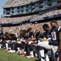 FILE - In this Sept. 24, 2017 file photo, several New England Patriots players kneel during the national anthem before an NFL football game against the Houston Texans in Foxborough, Mass. Patriots fans have burned team gear in protest after a number of players kneeled during the national anthem before last weekend's game. More than 100 people came out to Swansea, Massachusetts, on Thursday, Sept. 28 to throw Patriots T-shirts and other team apparel into a fire pit as they waved American flags and sang patriotic songs. (AP Photo/Michael Dwyer, File)