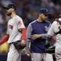 Boston Red Sox manager Alex Cora, center, takes starting pitcher Rick Porcello, left, out of the baseball game during the fourth inning against the Tampa Bay Rays on Thursday, May 24, 2018, in St. Petersburg, Fla. At right is catcher Sandy Leon. (AP Photo/Chris O'Meara)