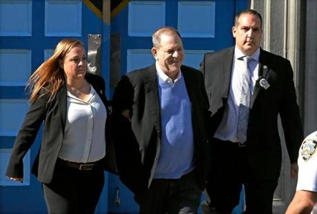 Harvey Weinstein is led in handcuffs from a New York City precinct to court to face charges of rape and sexual assault.  
