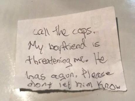 This undated photo provided by the Volusia County Sheriff's Office shows a note florida authorities say a woman slipped to a staff member at an animal hospital in Florida. Authorities say the woman was beaten and held captive for two days at gunpoint by her boyfriend, and escaped when she convinced him bring their dog to the animal hospital, where she slipped the note to a staff member. The Daytona Beach News-Journal reports 39-year-old Jeremy Floyd was arrested at DeLand Animal Hospital. (Volusia County Sheriff's Office via AP)
