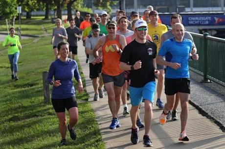 Runners, including venture capitalists, biotech executives, and scientists, finish a loop along Memorial Drive in Cambridge.
