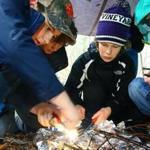 Zac Carvalho,10, Avery Cooper, 10, Lily Oliver, 9, and Cia Donohoe, 9, learn how to make a fire, as part of their survivor skills in their Boy Scouts Pack 30. The scouts are now accepting females, Pack 30, has three, Lily and Cia. Mark Lorenz for the Boston Globe. 