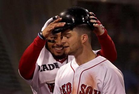 Boston Red Sox right fielder Mookie Betts celebrates after he and left fielder Andrew Benintendi hit back to back home runs during a game against the Baltimore Orioles at Fenway Park. 
