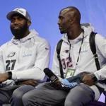 Philadelphia Eagles' Malcolm Jenkins (27) and New England Patriots' Devin McCourty answer questions during NFL football Super Bowl 52 Opening Night Monday, Jan. 29, 2018, at the Xcel Center in St. Paul, Minn. (AP Photo/Eric Gay)