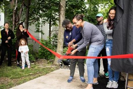 Neighborhood residents cut the ribbon to open the new Edson Street Connector pathway on Wednesday.
