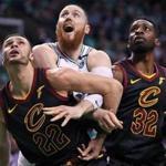 Boston, MA: 5-23-18: The Celtics Aron Baynes (center) is squeezed between the Cavaliers Larry Nance, Jr. (left) and Jeff Green (right) under the boards. The Boston Celtics hosted the Cleveland Cavaliers for Game Five of their NBA Eastern Conference Finals playoff series at the TD Garden. (Jim Davis/Globe Staff)