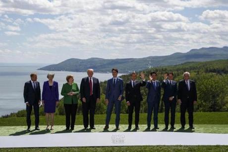 From left, President of the European Council Donald Tusk, British Prime Minister Theresa May, German Chancellor Angela Merkel, U.S. President Donald Trump, Canadian Prime Minister Justin Trudeau, French President Emmanuel Macron, Japanese Prime Minister Shinzo Abe, Italian Prime Minister Giuseppe Conte and President of the European Commission Jean-Claude Juncker gather for the family photo at the G-7 summit, Friday, June 8, 2018, in Charlevoix, Canada. (AP Photo/Evan Vucci)
