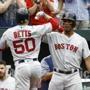 Boston Red Sox's Xander Bogaerts, right, greets teammate Mookie Betts after Betts rounded the bases on a solo home run in the third inning of a baseball game against the Baltimore Orioles, Wednesday, June 13, 2018, in Baltimore. (AP Photo/Patrick Semansky)