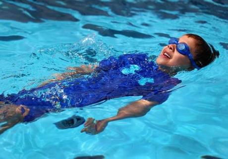 Boston's Mirabella Pool in the North End opened for the year. Wes Roehl, 7, from, swam backward in the water on Saturday.
