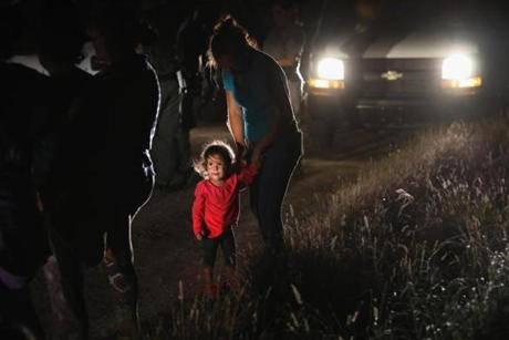 MCALLEN, TX - JUNE 12: A two-year-old Honduran stands with her mother after being detained by U.S. Border Patrol agents near the U.S.-Mexico border on June 12, 2018 in McAllen, Texas. The asylum seekers had rafted across the Rio Grande from Mexico and were detained before being sent to a Border Patrol processing center for possible separation. Customs and Border Protection (CBP) is executing the Trump administration's 