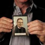Jim Graham with a picture of the Rev. Thomas Sullivan, who he contends was his father.  Suzanne Kreiter/Globe staff)