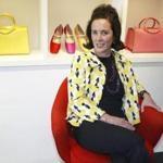 FILE - In this May 13, 2004, file photo, designer Kate Spade sits during an interview in New York. Kate Spade New York has announced plans to donate $1 million to support suicide prevention and mental health awareness causes in tribute to the company?s late founder. The 55-year-old fashion designer killed herself June 5, 2018. Her husband says she suffered from depression and anxiety for many years. (AP Photo/Bebeto Matthews, File)