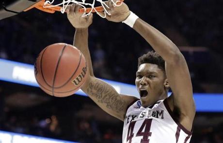 Texas A&M's Robert Williams dunks against Providence during the second half of a first-round game in the NCAA men's college basketball tournament in Charlotte, N.C., Friday, March 16, 2018. (AP Photo/Gerry Broome)
