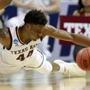 CHARLOTTE, NC - MARCH 16: Robert Williams #44 of the Texas A&M Aggies dives for ball possession againt Kyron Cartwright #24 of the Providence Friars during the first round of the 2018 NCAA Men's Basketball Tournament at Spectrum Center on March 16, 2018 in Charlotte, North Carolina. (Photo by Streeter Lecka/Getty Images) *** BESTPIX ***