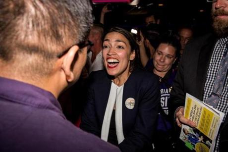 Alexandria Ocasio-Cortez celebrated with supporters Tuesday after she stunned Representative Joseph Crowley of New York in a Democratic primary race.
