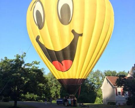 A cheery-looking hot air balloon made a surprise landing in a Methuen neighborhood Tuesday. 
