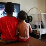 ANDOVER, MA - 06/28/2018 Gerdan, (left) nine, sits with brother Killian, two, and plays video games in the living room of their hotel. The family has moved to several different hotel rooms over the last few months, but this will probably be the last. The Federal Emergency Management Agency is officially ending its Temporary Sheltering Assistance Program for Puerto Rico, a program that has paid for hotel rooms for thousands of evacuees for nearly a year after Hurricane Maria devastated the island. Erin Clark for the Boston Globe