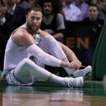Boston, MA: 3/20/2018: The Celtics Aron Baynes had one of his sneakers come off under the Thunder basket in the first half, (photo 1A) as the play went back up court, he was forced to sit on the parquet and try to get it back on quickly, but he didn't have a chance to finaish before Oklahoma City's Russell Westbrook came thundering down for a drive, Baynes leapt to his feet to try and help out on defense and ended up going flying (photo 1B) Teammate Jayson Tatum (0) had already been called for a foul in the drive though. The Boston Celtics hosted the Oklahoma City Thunder in a regular season NBA basketball game at the TD Garden. (Jim Davis/Globe Staff)
