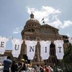 In Austin, Texas, a demonstrator used baby clothes to spell out the word ?reunite? during a rally outside the Texas Capitol.