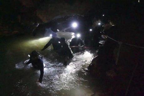 Thai rescue workers inside the cave complex where 12 boys and their soccer coach went missing. 
