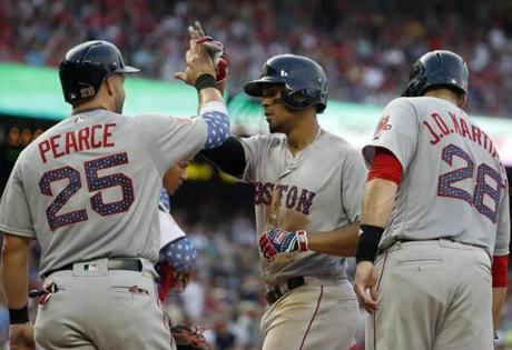 Boston Red Sox' Steve Pearce, left, Xander Bogaerts, and J.D. Martinez celebrate Bogaerts' three-run home run during the fifth inning of an interleague baseball game against the Washington Nationals at Nationals Park Tuesday, July 3, 2018, in Washington. (AP Photo/Alex Brandon)
