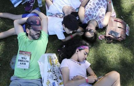 SLIDER--Jose Hernandez, left, and his wife, Daniella, right, relax in the shade with their children (top to bottom) Carlos, 15, Santi, 11, and Ana, 13, while waiting for the Boston Pops Fireworks Spectacular to begin at the Hatch Shell on the Esplanade in Boston, MA on July 04, 2018. (Craig F. Walker/Globe Staff) section: metro reporter:
