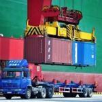 Shipping containers are transferred at a port in Qingdao in China?s eastern Shandong province on Friday.