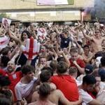England soccer fans celebrate on the final whistle as they watch a live broadcast on a big screen of the quarterfinal match between England and Sweden at the 2018 soccer World Cup, in Flat Iron Square, south London, Saturday, July 7, 2018. (AP Photo/Matt Dunham)