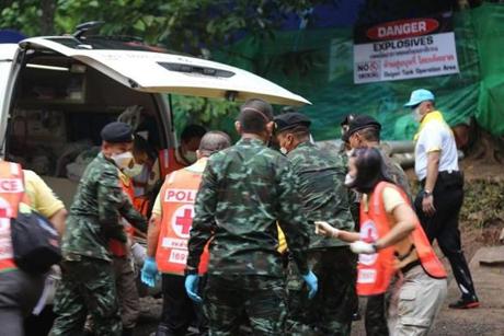 In this handout photo taken and released by Chiang Rai Public Relations Office on July 8, 2018 shows Thai soldiers and paramedics assist a rescued boy on a stretcher to an ambulance in Tham Luang cave area after divers evacuated some of the 12 boys and their coach trapped in the cave in Khun Nam Nang Non Forest Park in the Mae Sai district on July 8, 2018. Foreign elite divers and Thai Navy SEALS on July 8 began the extremely dangerous operation to extract the 12 boys and their football coach as they raced against time, with imminent monsoon rains threatening more flooding that would doom the rescue operation. / AFP PHOTO / CHIANG RAI PUBLIC RELATIONS OFFICE / Handout / XGTY - RESTRICTED TO EDITORIAL USE - MANDATORY CREDIT 