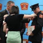 Kerry Farr pinned her husband, Noah D. Farr, at the Boston Fire Academy graduation