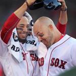 Boston, MA: 7-9-18: The Red Sox Mookie Betts (left) removes the batting helmet of teammate Steve Pearce (right) after Pearce hit a two run home run in the bottom of the first inning during his first at bat at Fenway Park in a Red Sox uniform. The Boston Red Sox hosted the Texas Rangers in regular season MLB baseball game at Fenway Park. (Jim Davis/Globe Staff) 