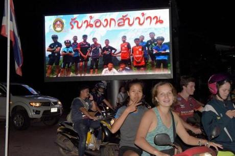 Motorists passed a billboard with a photograph showing members of the Thai children's football team 