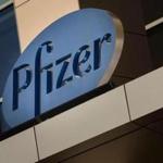 (FILES) In this file photo taken on March 18, 2017, a sign for Pfizer pharmaceutical company is seen on a building in Cambridge, Massachusetts. Pfizer reported increased first-quarter profits on May 1, 2018, on slightly higher sales, but results were dented somewhat by a US patent expiration on blockbuster drug Viagra. Net income came in at $3.6 billion, up 14.1 percent. Revenues rose 1.0 percent to $12.9 billion. / AFP PHOTO / DOMINICK REUTERDOMINICK REUTER/AFP/Getty Images