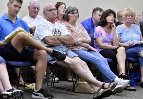 MILLVILLE, 7/4/2018 - Town residents look on during a special Board of Selectmen outlining cuts to town services. Voters rejected a Prop 2 1/2 override vote forcing the town to end trash service, closed its senior center, and to turn off more than half of it's street lights. Josh Reynolds for The Boston Globe (Metro, Crimaldi) 
