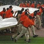 BALTIMORE, MD - JULY 25: The grounds crew pulls the rain tarp onto the field during the second inning as the Baltimore Orioles play the Boston Red Sox at Oriole Park at Camden Yards on July 25, 2018 in Baltimore, Maryland. (Photo by Patrick Smith/Getty Images)