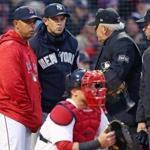 Boston, MA: 4/9/2018: Managers Alex Cora of the Red Sox and Aaron Boone of the Yankees meet with the umpires at home plate before the start of the game. The Boston Red Sox hosted the New York Yankees in a regular season MLB baseball game at Fenway Park. (Jim Davis/Globe Staff)