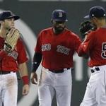 Boston Red Sox outfielders, from left, Andrew Benintendi, Jackie Bradley Jr. and Mookie Betts celebrates after defeating the Tampa Bay Rays during the ninth inning of a baseball game in Boston, Friday, Aug. 17, 2018. (AP Photo/Michael Dwyer)