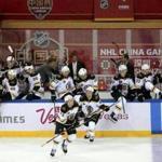 Members of the Boston Bruins celebrate after winning their game against the Calgary Flames in the 2018 NHL China Games in Shenzhen in southern China's Guangdong province, Saturday, Sept. 15, 2018. Boston beat Calgary 4-3 in a shootout. (Color China Photo via AP)