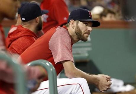 Boston Red Sox starting pitcher Chris Sale looks on from the dugout during the seventh inning of a baseball game against the Houston Astros Friday, Sept. 7, 2018, in Boston. (AP Photo/Winslow Townson)
